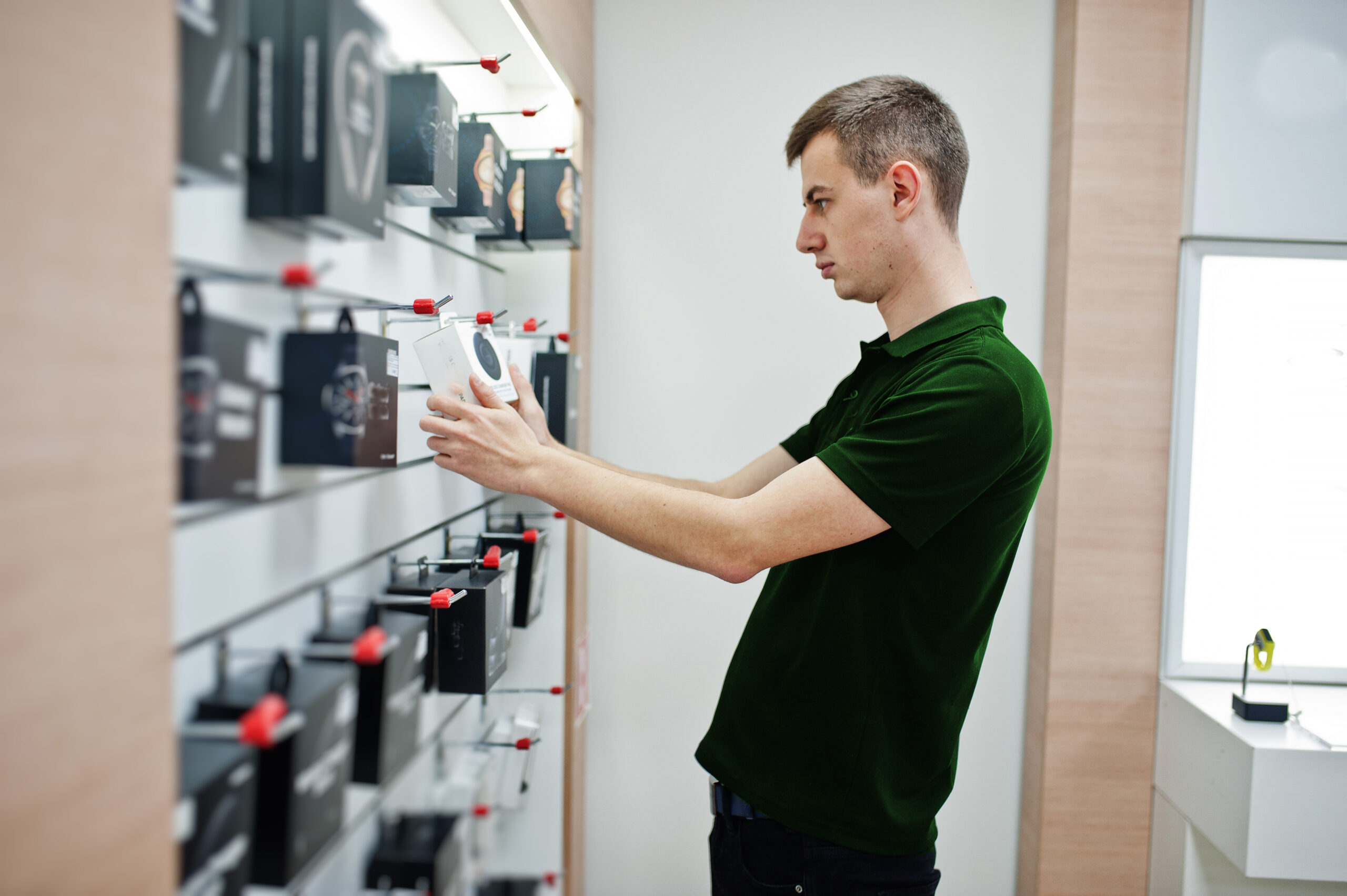 Seller man mobile phone professional consultant in tech store or