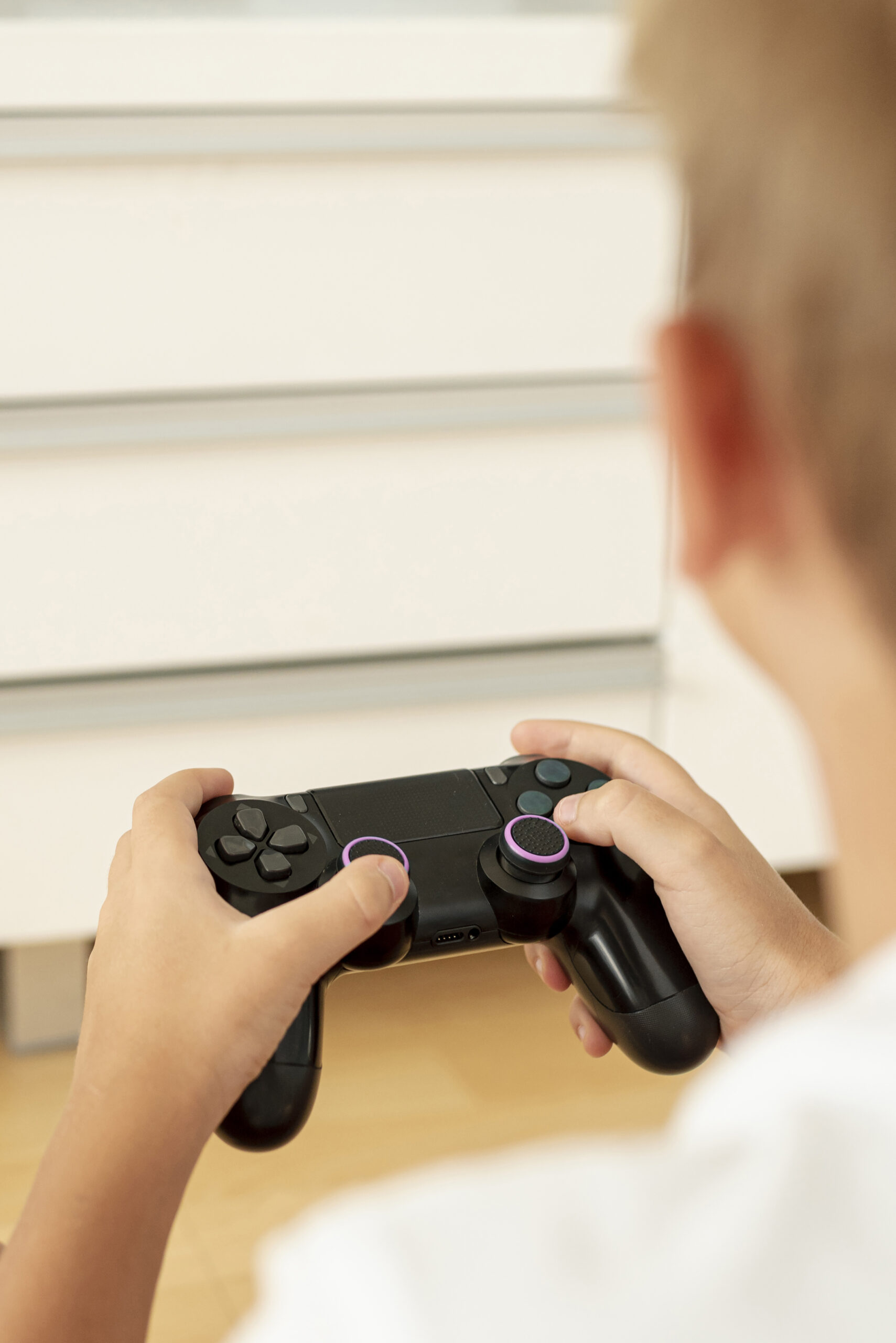 close-up-boy-playing-with-controller