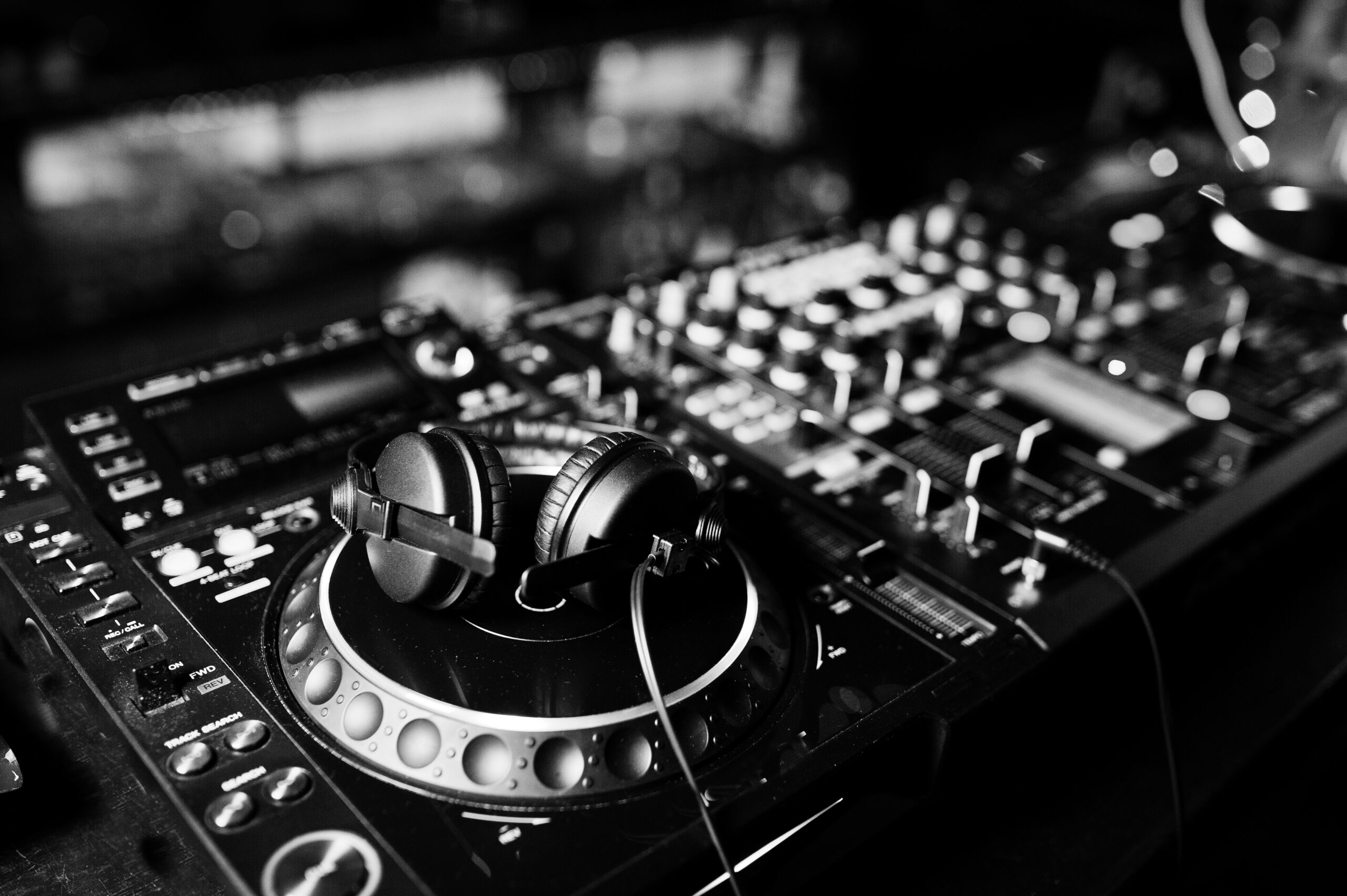 DJ spinning mixing and scratching track controls on dj's deck st