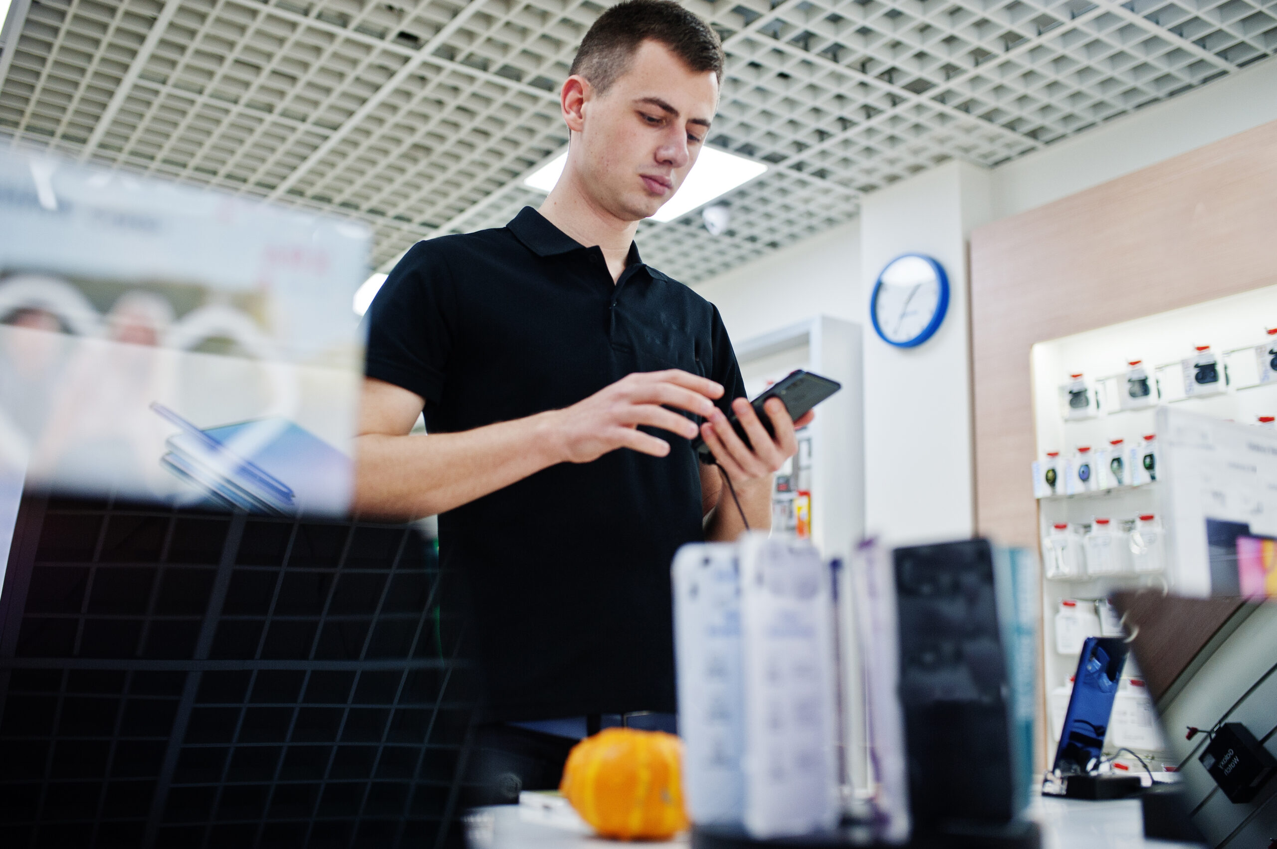Seller man mobile phone professional consultant in tech store or