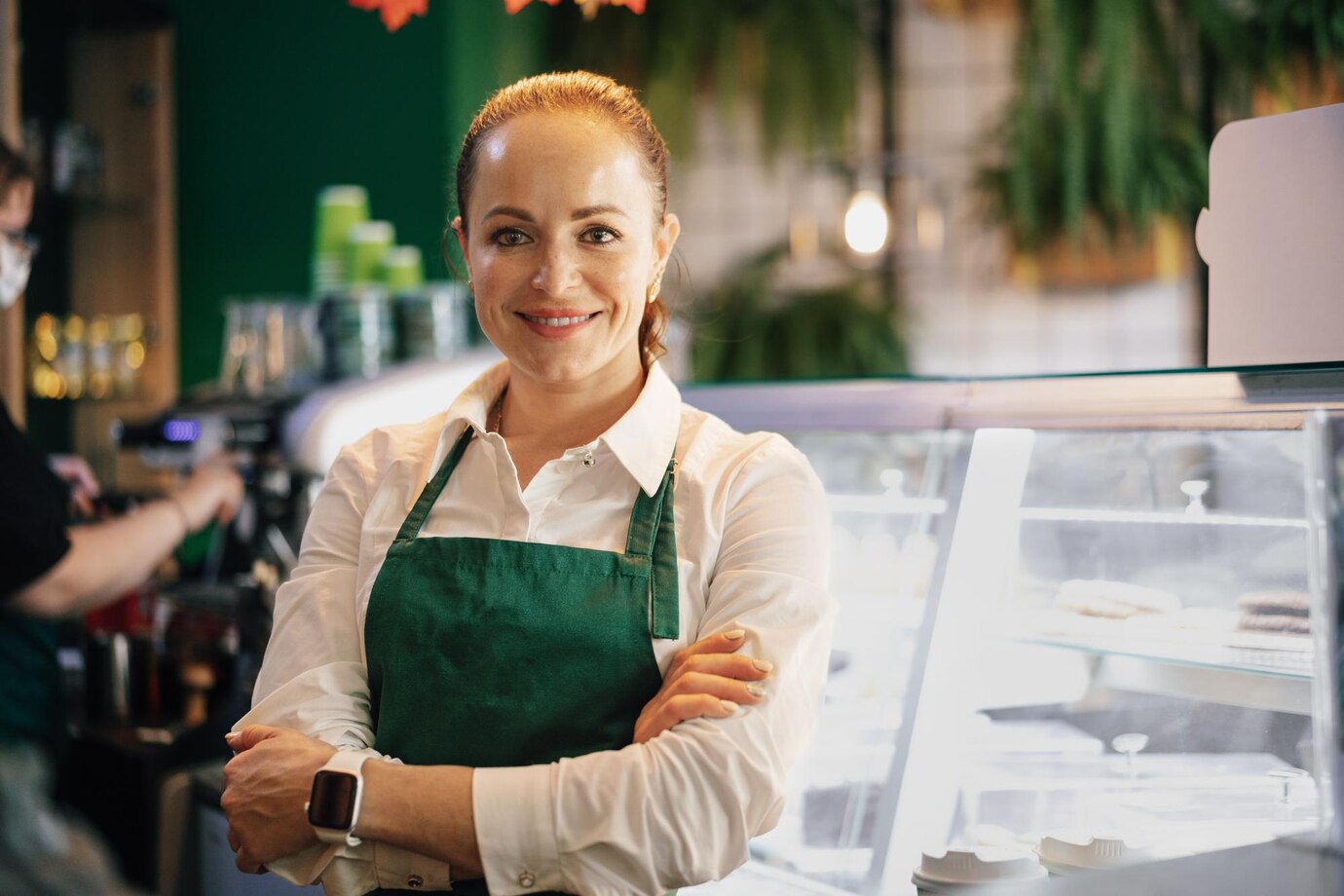 young-female-barista-standing-inside-coffee-counter_93675-134691