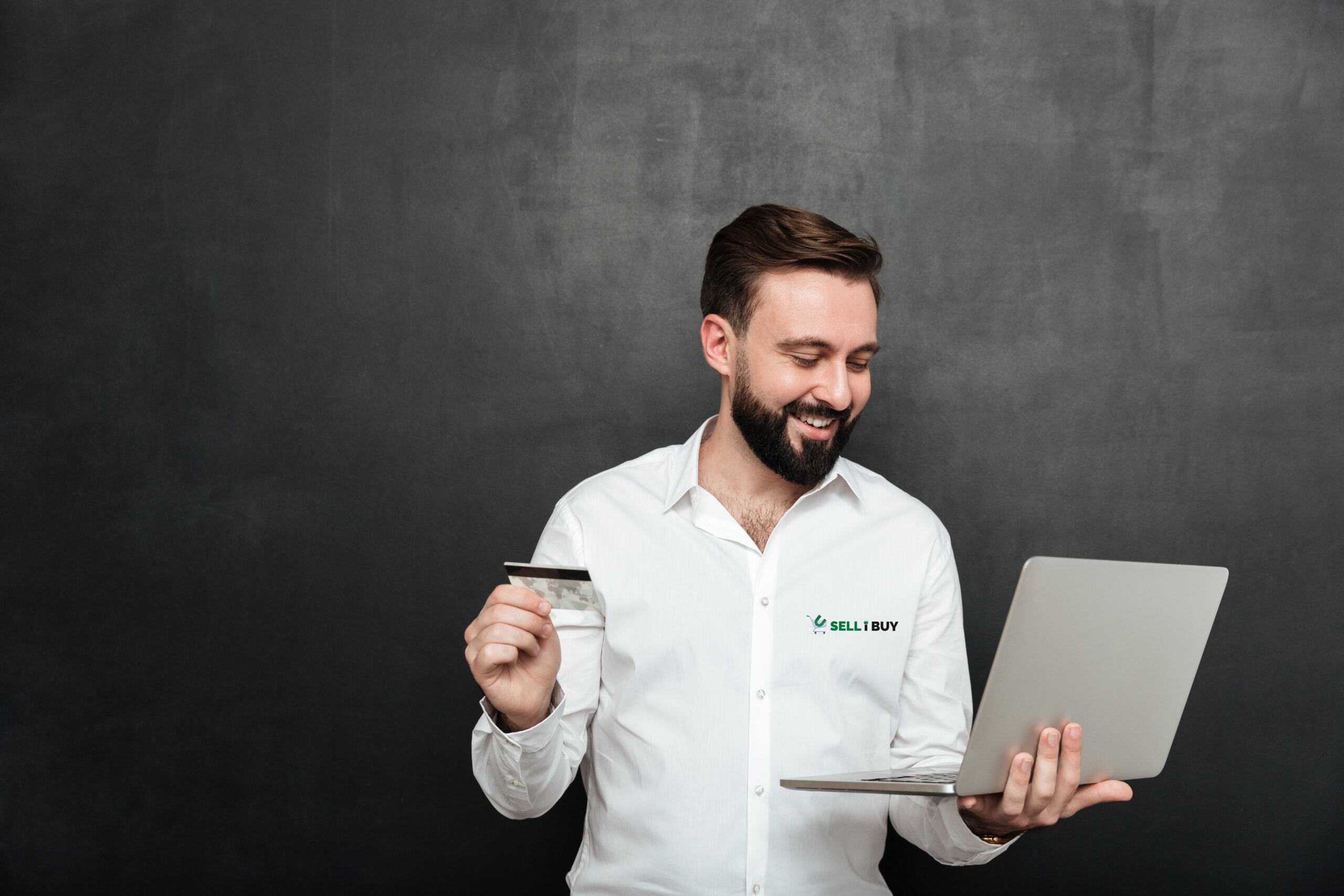 Portrait of cheerful man doing online payment in internet using